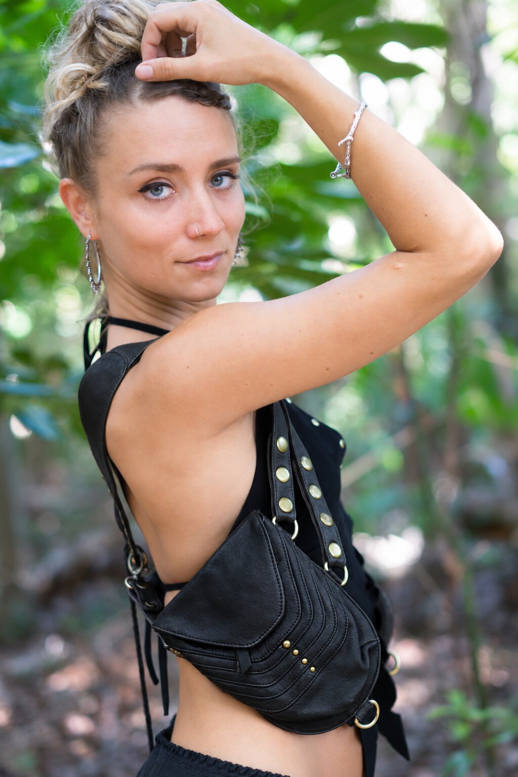 Black leather holster with chain and stud accents, worn at hip